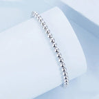 Bracelet boule de perles élastique or blanc