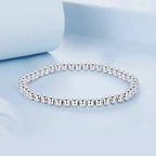 Bracelet boule de perles élastique or blanc
